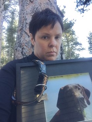 Amy with photo of her dog Abby